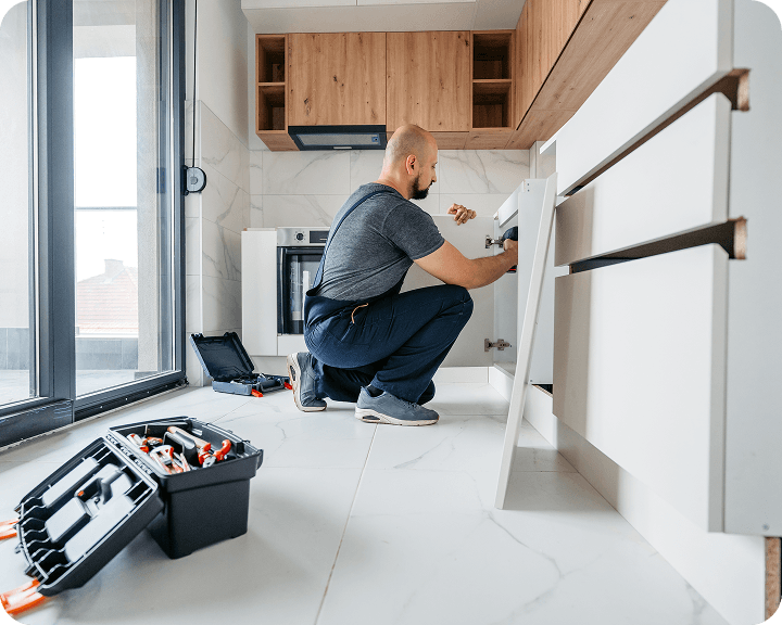 Man repairing under-sink plumbing