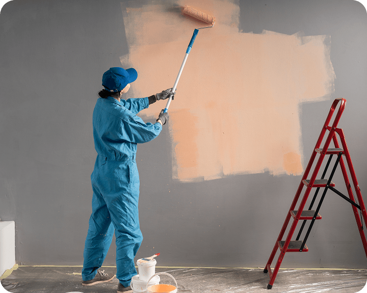 Person painting wall with roller
