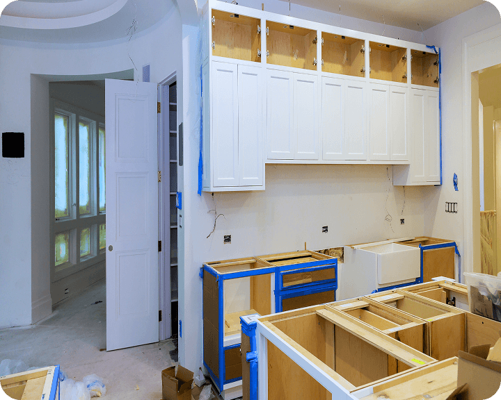 Unfinished kitchen with taped cabinets